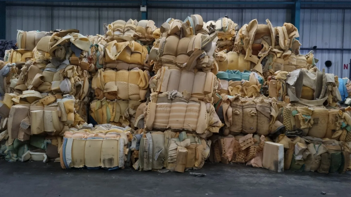 Compressed bales of recovered mattress foam